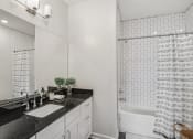 Thumbnail 16 of 36 - a white bathroom with a sink and a shower