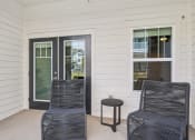 Thumbnail 13 of 36 - a front porch with two chairs and a small table