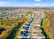 Thumbnail 10 of 11 - A suburban neighborhood with houses and a road.