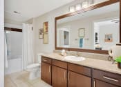 Thumbnail 14 of 48 - a bathroom with a sink and a toilet and a mirror