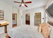 Thumbnail 11 of 48 - a bedroom with a large bed and a ceiling fan