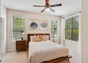 Thumbnail 10 of 48 - a bedroom with a large bed and a ceiling fan