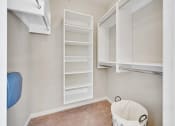 Thumbnail 12 of 48 - a laundry room with white cabinets and a trash can