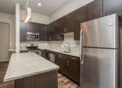 Thumbnail 10 of 33 - a kitchen with stainless steel appliances and a counter top