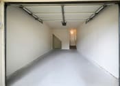 Thumbnail 10 of 36 - a empty room in a garage with a white wall