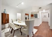 Thumbnail 4 of 36 - a dining room with a table and chairs and a kitchen