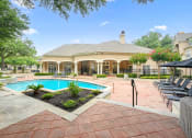 Thumbnail 1 of 36 - a house with a swimming pool and a patio with chairs