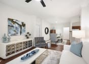 Thumbnail 6 of 36 - a living room with a white couch and a dining room table