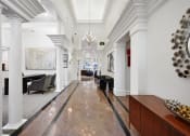Thumbnail 26 of 36 - a long hallway with white pillars and a marble floor