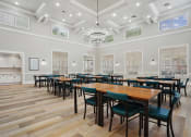 Thumbnail 15 of 25 - a dining room with tables and chairs and a kitchen