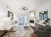 Thumbnail 7 of 36 - a living room with a white couch and a fireplace