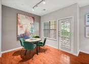 Thumbnail 8 of 48 - a dining room with a table and chairs and a window