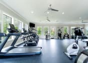 Thumbnail 36 of 48 - a gym with treadmills and other exercise equipment