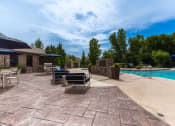 Thumbnail 19 of 48 - a backyard with a pool and patio with chairs and umbrellas
