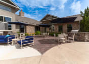 Thumbnail 20 of 48 - a patio with chairs and umbrellas in front of a house