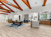 Thumbnail 41 of 71 - A spacious clubhouse and kitchen area with wooden floors and ceiling beams.
