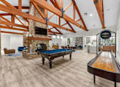Thumbnail 60 of 71 - A pool table is in the middle of a room with a fireplace and wooden beams.