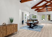 Thumbnail 50 of 71 - A dining room with a wooden table and chairs.