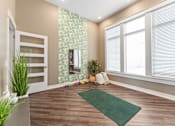 Thumbnail 21 of 22 - A room with a green rug on the floor and a white door on the left.