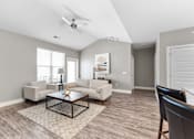 Thumbnail 6 of 22 - A living room with a ceiling fan and a rug on the floor.