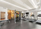 Thumbnail 27 of 47 - A gym with treadmills and a treadmill with a sign on it.