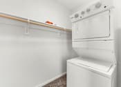 Thumbnail 29 of 47 - A white oven and dryer in a small room.