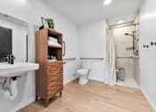 Thumbnail 53 of 53 - A bathroom with a wooden cabinet and a white sink.
