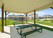Thumbnail 16 of 16 - A green picnic table is under a white canopy.