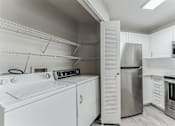 Thumbnail 10 of 22 - A modern kitchen with stainless steel appliances and white cabinetry.