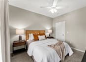 Thumbnail 5 of 71 - A bedroom with two beds and a ceiling fan.