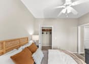 Thumbnail 4 of 71 - A bedroom with a bed, pillows, and a ceiling fan.