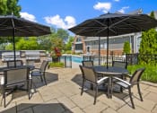 Thumbnail 21 of 37 - Patio Table, chairs, and umbrellas by a pool