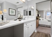 Thumbnail 4 of 37 - an open kitchen with white cabinets and a bedroom with a bed