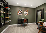 Thumbnail 5 of 30 - A room with a desk, chair, and shelves.