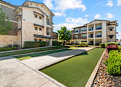 Thumbnail 44 of 47 - A modern apartment complex with a well-maintained lawn and landscaping.