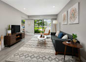 Thumbnail 3 of 30 - A living room with a grey couch, a wooden coffee table, and a television.