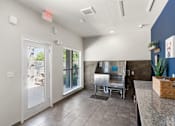 Thumbnail 41 of 47 - A kitchen area with a stainless steel sink and a window with a view of the backyard.