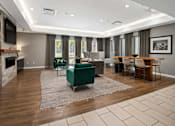 Thumbnail 17 of 30 - A modern living room with a fireplace and a dining area.
