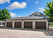 Thumbnail 47 of 47 - A two-story building with a garage door on each floor.