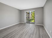 Thumbnail 19 of 30 - A room with a sliding glass door leading to a balcony.