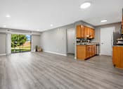 Thumbnail 21 of 30 - A spacious kitchen with wooden cabinets and a marble countertop.