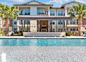 Thumbnail 17 of 47 - A large house with a pool in front.