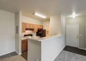 Thumbnail 14 of 23 - an open kitchen with a counter top and a door to a living room