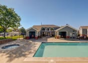 Thumbnail 7 of 23 - a swimming pool with a house in the background