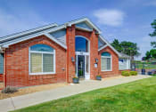 Thumbnail 2 of 23 - the front of a brick house with a sidewalk and grass