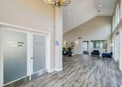 Thumbnail 4 of 23 - a large lobby with doors and chairs and a chandelier