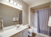 Thumbnail 28 of 32 - Bathroom with large vanity and lots of counter space, tub and shower combination, wood flooring