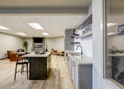 Thumbnail 13 of 25 - A modern office space with a kitchenette area.