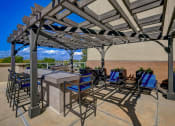 Thumbnail 32 of 33 - a patio with tables and chairs and a pergola