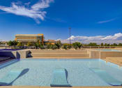 Thumbnail 26 of 33 - a pool with a building in the background
